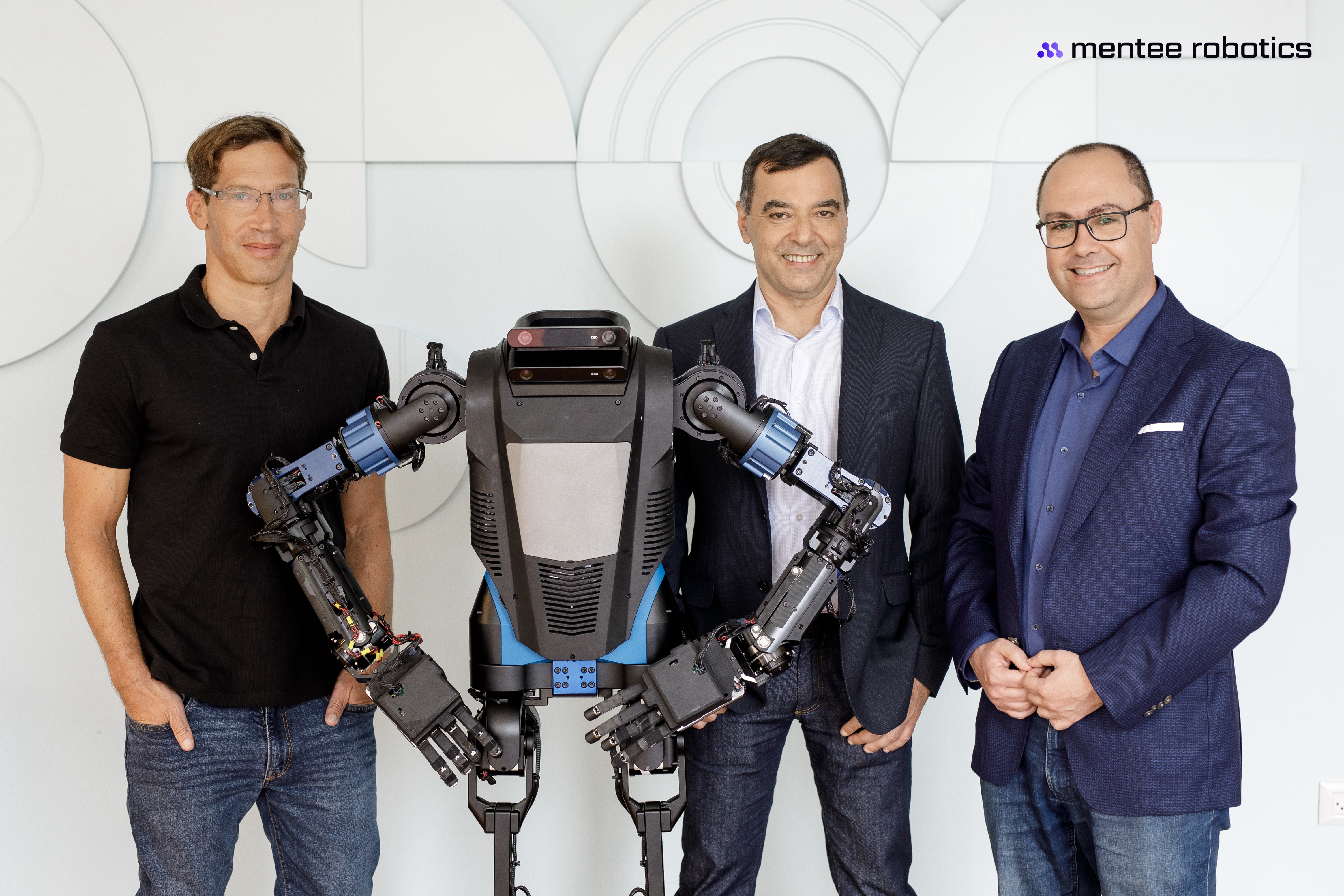 Mentee Robotics team with its humanoid robot prototype