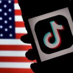 In this photo illustration, the social media application logo, TikTok is displayed on the screen of an iPhone on an American flag background on August 3, 2020 in Arlington, Virginia. - The US Senate voted on August 6, 2020, to bar TikTok from being downloaded onto US government employees' telephones, intensifying US scrutiny of the popular Chinese-owned video app. The bill passed by the Republican controlled Senate now goes to the House of Representatives, led by Democrats. (Photo by Olivier DOULIERY / AFP) (Photo by OLIVIER DOULIERY/AFP via Getty Images)