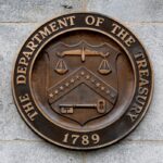 Seal of the U.S. Treasury logo on the wall of the Treasury building in DC