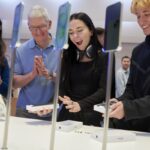 Tim Cook, chief executive officer of Apple Inc., second left, at the company's Fifth Avenue store in New York